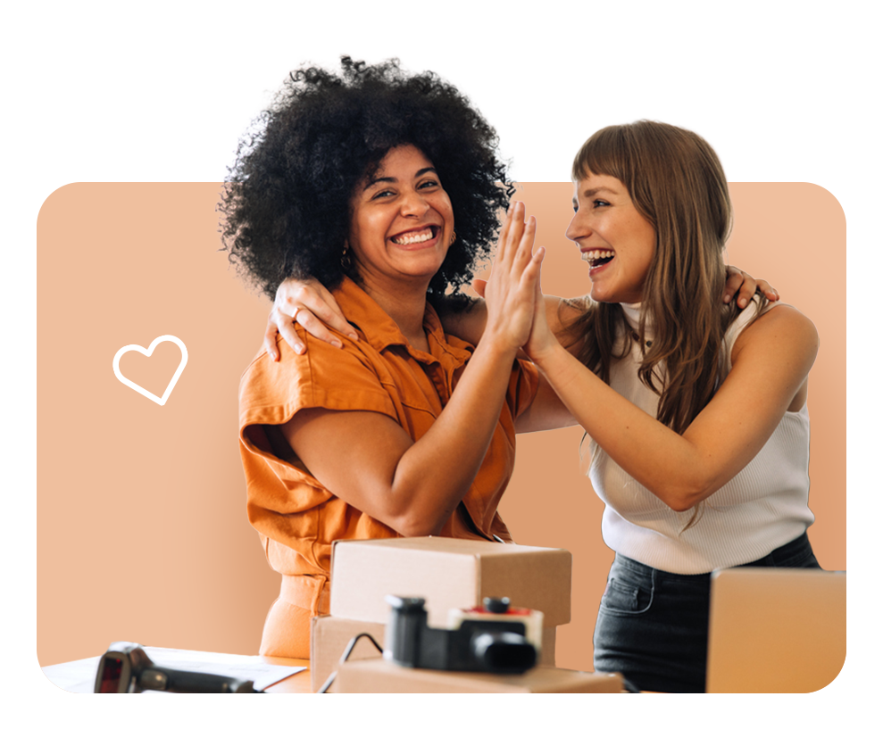 Team members celebrating in office, reflecting FrankCrum’s premium benefits offerings that help small businesses compete for top talent