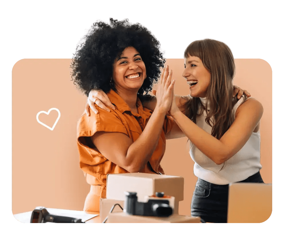 Team members celebrating in office, reflecting FrankCrum’s premium benefits offerings that help small businesses compete for top talent