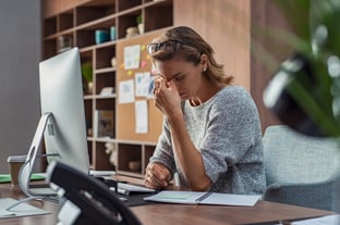 women working holds her head