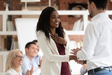 employee is thrilled when manager congratulates her and shows his appreciation