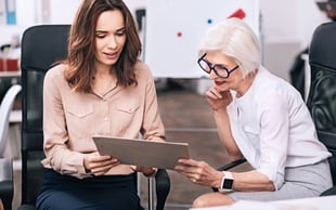 a young worker has a face-to-face meeting with an employee from the Boomer generation.