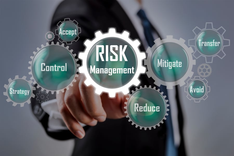 man pointing at screen that says risk management