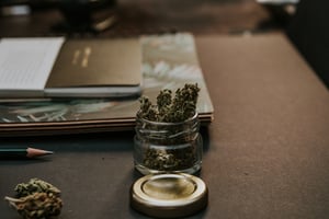 marijuana in a jar on a worker's desk