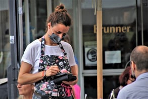 small business waitress takes a customer's order